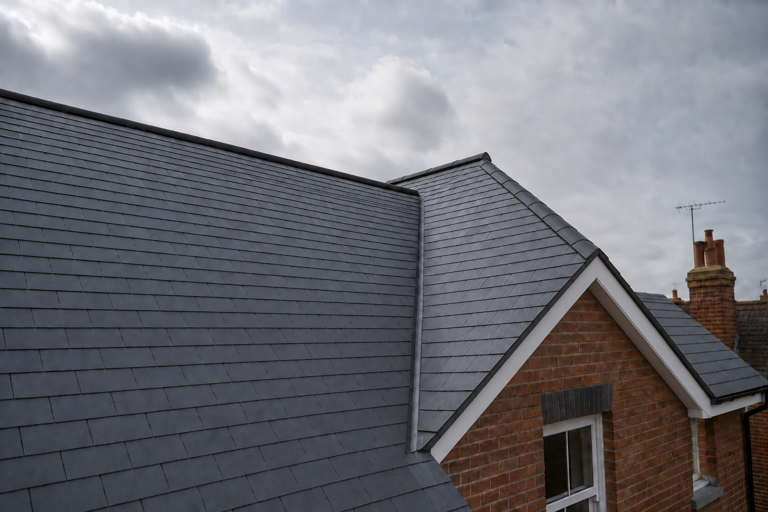 Professionally finished slate roofing with a complete gable edge on a British home